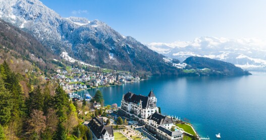 Aerial view of Park Hotel Vitznau beside lake in mountains