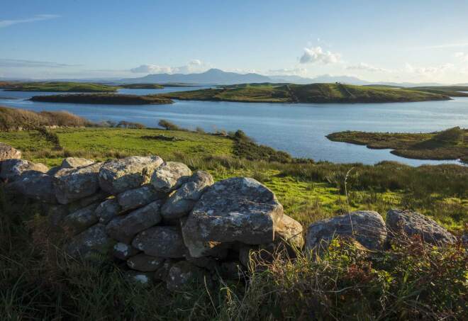 A view of stone walls and lakes over Sky Road in Galway County