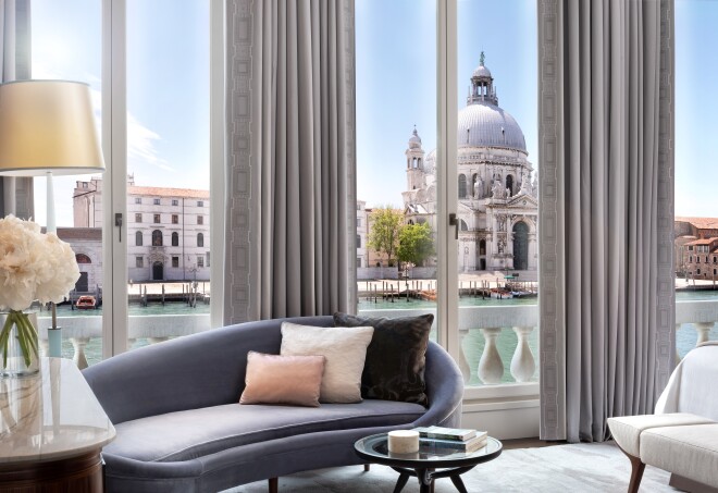 This guest room at the St. Regis Venice features a chaise longue and a balcony with views of the Grand Canal.