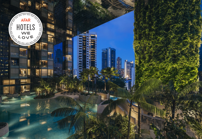 The pool at the Pan Pacific Orchard in Singapore features city views and has a large plant wall.