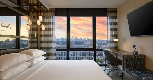 This bedroom at the Renaissance New York Harlem Hotel has views of the city skyline.