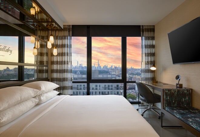 This bedroom at the Renaissance New York Harlem Hotel has views of the city skyline.