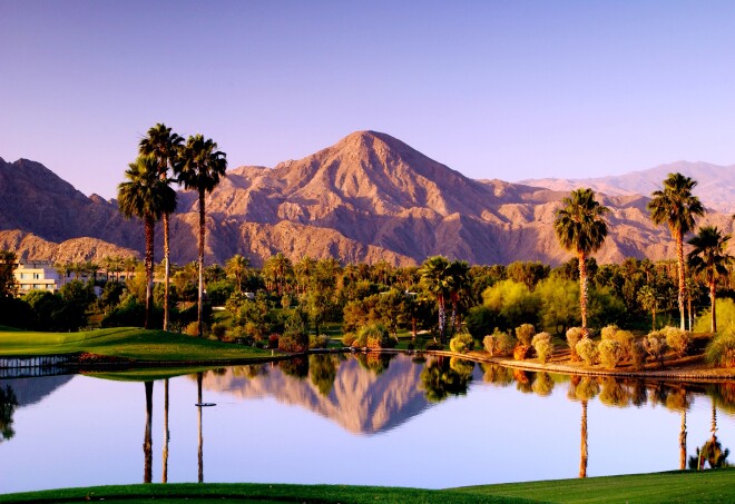 A view of the purple mountains reflecting in a pond at the Indian Wells Golf Resort in the Greater Palm Springs, California.          