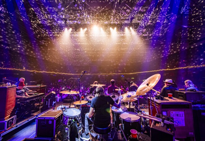 A view from behind a band performing from onstage looking out onto an audience at Harrah's Cherokee Center, Asheville, North Carolina